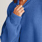 Woman wearing Double Take Side Slit Round Neck Long Sleeve Sweater in blue.