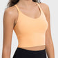 Model wearing a lightweight orange active tank top with a sleek design, perfect for workouts and casual wear.