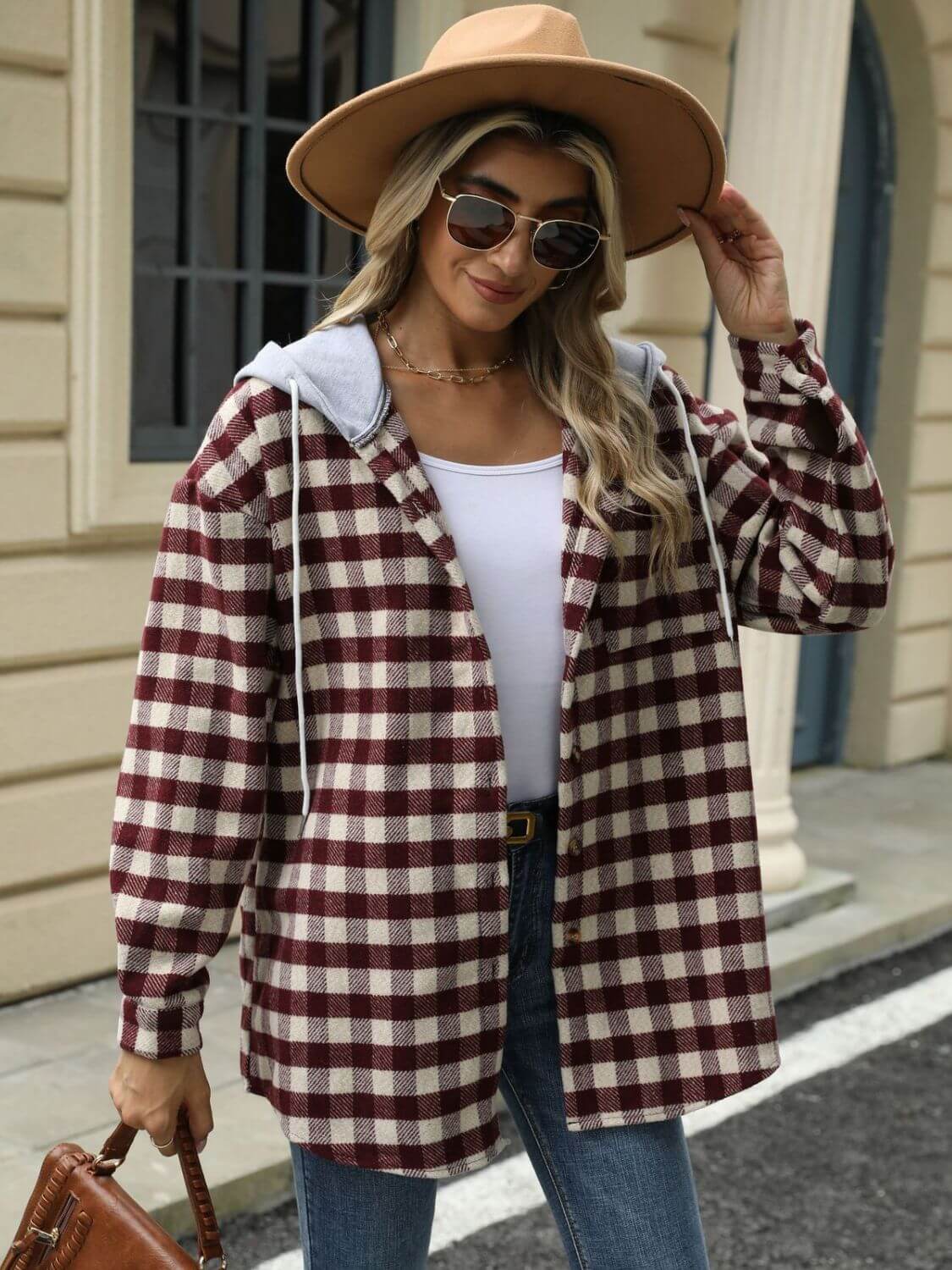 Woman wearing Bella Road Drawstring Plaid Long Sleeve Hooded Jacket with hat and sunglasses, standing in front of a building.