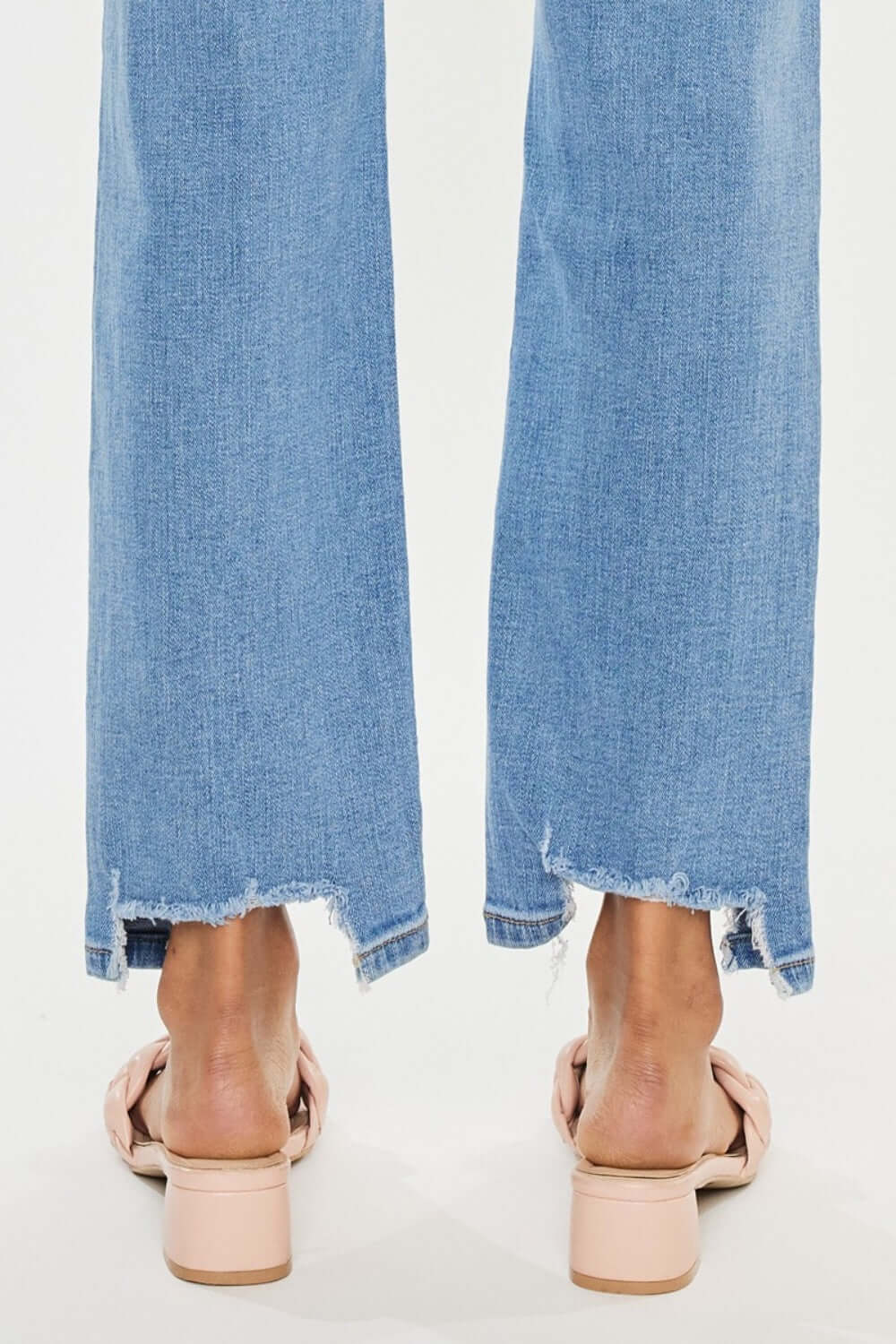 High Waist Raw Hem Straight Jeans with frayed edges, featuring a stylish and flattering high waist design, paired with casual heels.