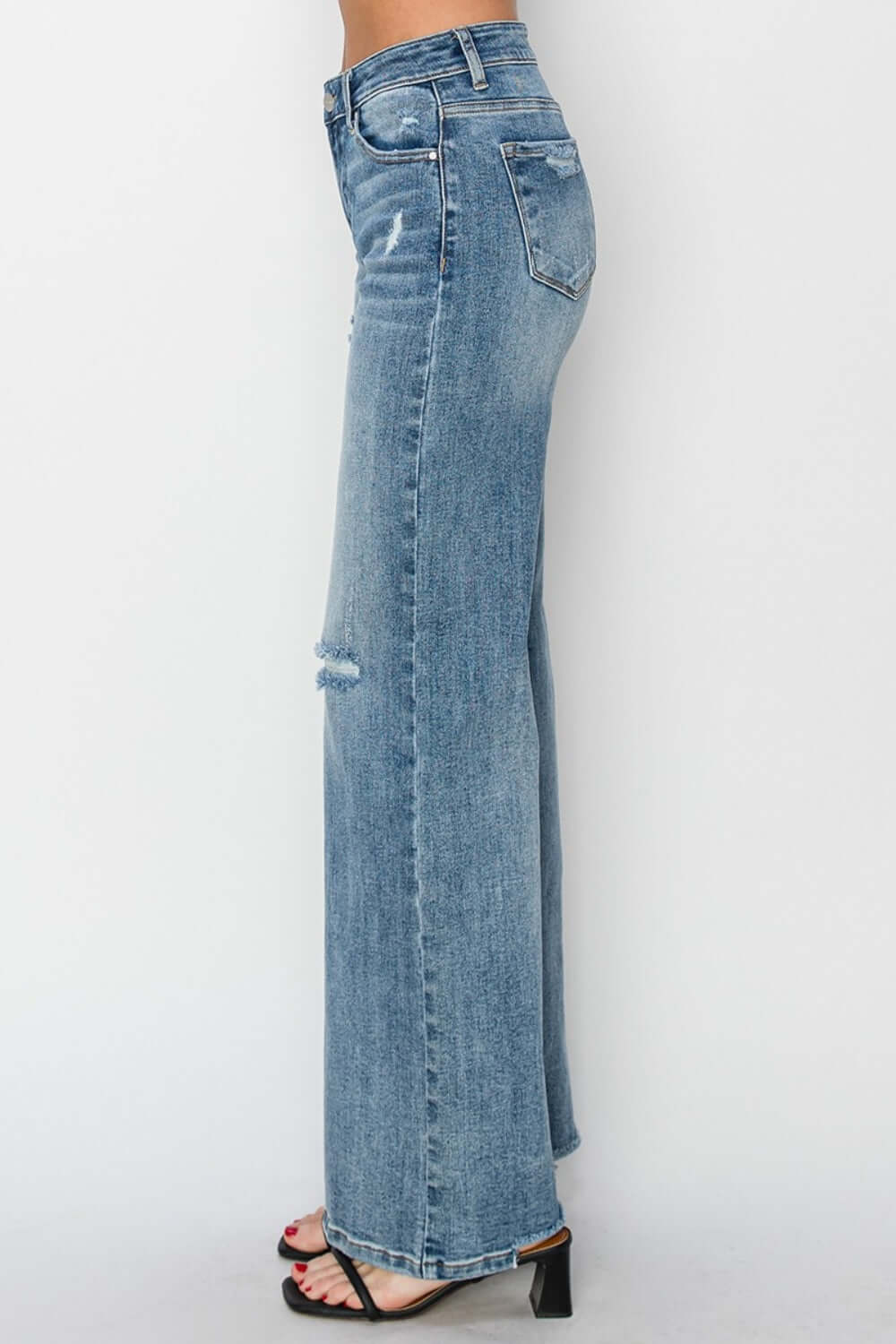 High waist distressed wide leg Risen Jeans with trendy design and edgy flair on model