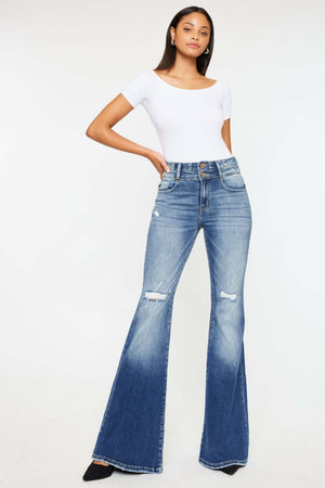 Woman wearing Kancan High Rise Flare Jeans with distressed detailing and wide waistband in a stylish pose