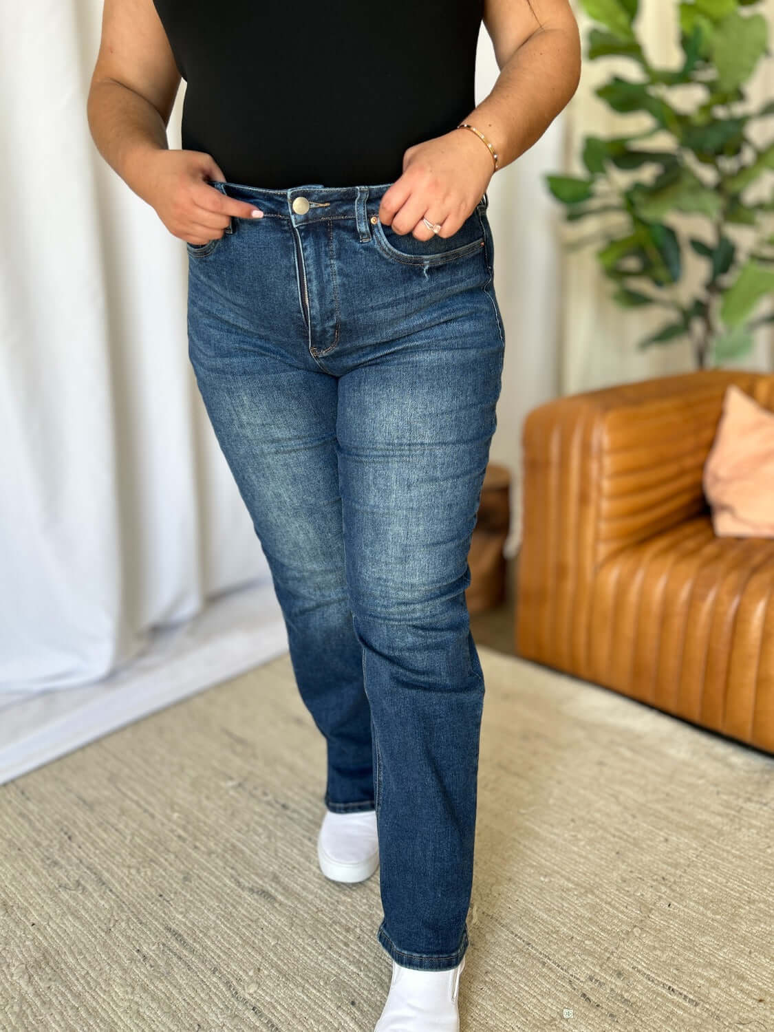 Woman wearing RFM Full Size High Rise Straight Tummy Control Jeans, showing high waist and straight-leg style for a sleek silhouette.