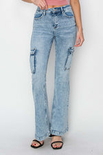 Risen high rise cargo flare jeans with utility pockets, high-waisted design, and trendy retro vibe in light blue denim.