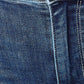 Close-up of mid-rise Judy Blue Jeans showing button and distressed denim fabric texture