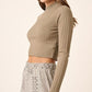 Stylish model showcasing the Mittoshop Mock Neck Long Sleeve Crop Knit Top paired with trendy patterned pants.