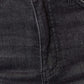 Close-up of tummy control high waist black denim jeans showing front pocket and waistband stitching.