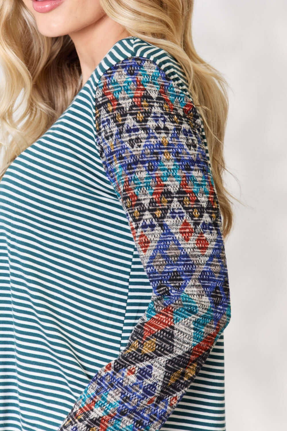 Close-up of Striped Round Neck Geometric Long Sleeve T-Shirt with colorful geometric patterns on the sleeves