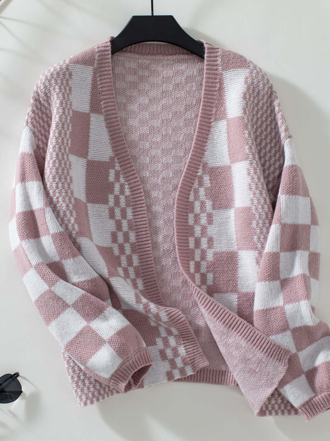 Dusty pink checkered open front cardigan with dropped shoulders, perfect for a stylish and cozy look.