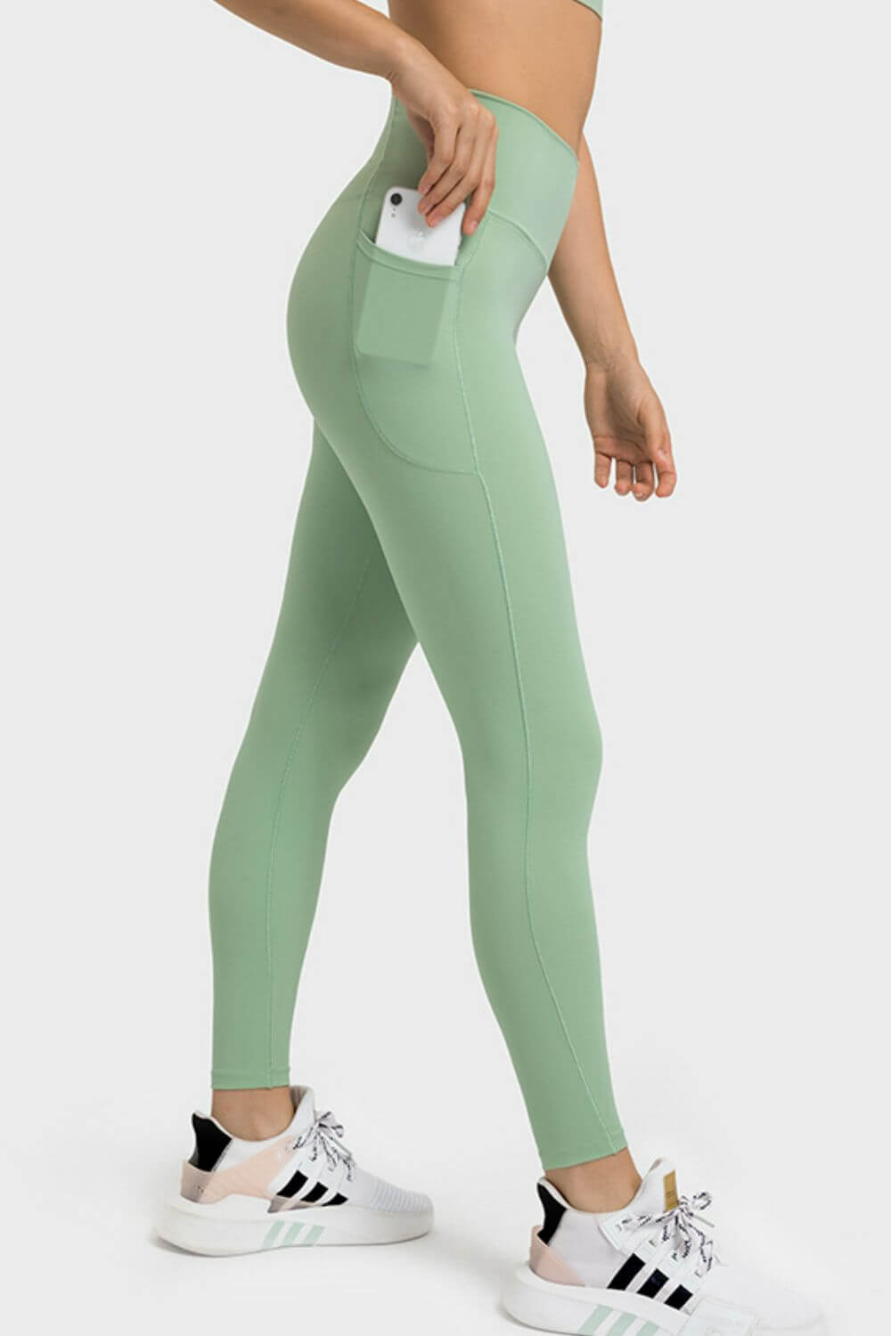 Millennia V-Waist Yoga Leggings in green featuring a side pocket, perfect for a stylish and comfortable workout.