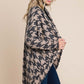 Woman wearing a BOMBOM houndstooth cocoon knit cardigan with open front design, showcasing its chic and cozy style.