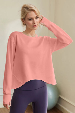 Model wearing a trendy Basic Bae Air Scuba Round Neck Long Sleeve Sweatshirt in sherbet color.