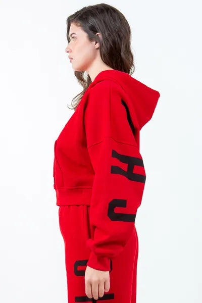 Side view of a woman wearing a red 'Chicago' graphic cropped hoodie with a drawstring and pocket, showcasing a trendy street style.