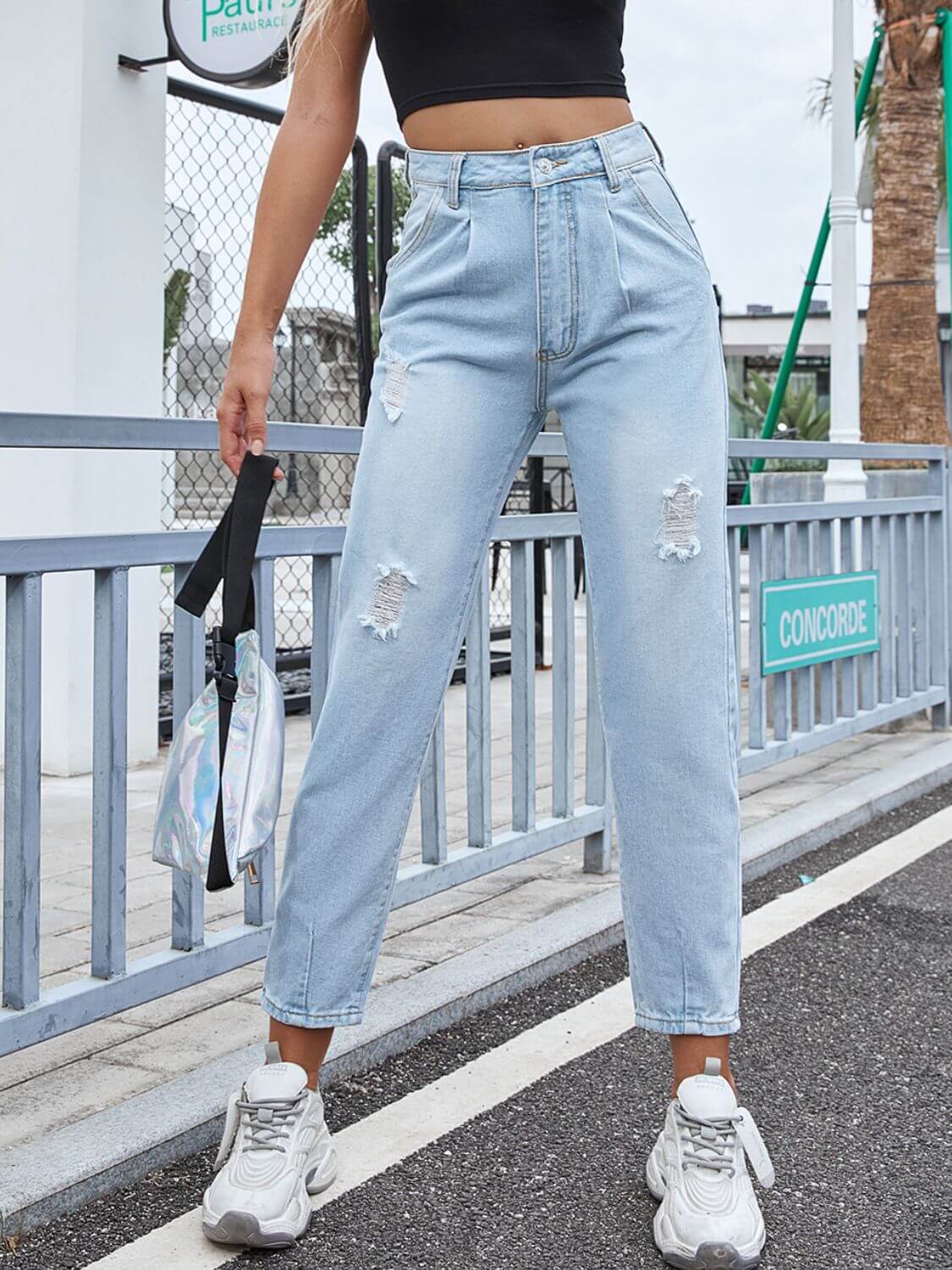 Woman wearing Bella Road Distressed Straight Jeans with Pockets, showcasing a trendy street style look.