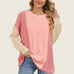 Woman wearing Double Take Texture Contrast long sleeve t-shirt in pink and beige, showcasing trendy layered style.