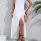 Woman wearing a white backless tassel surplice spaghetti strap cover up dress with a woven bag and sandals