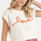 Stylish woman wearing a cream cap sleeve knit top with 'love' contrast lettering, perfect for casual outfits.