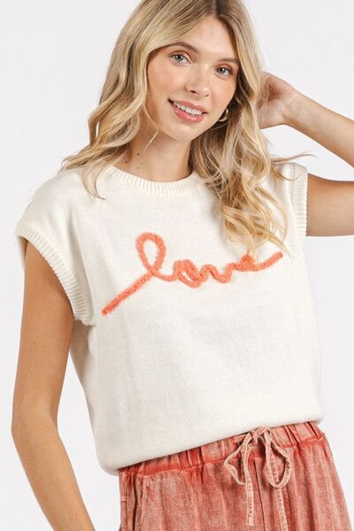 Stylish woman wearing a cream cap sleeve knit top with 'love' contrast lettering, perfect for casual outfits.