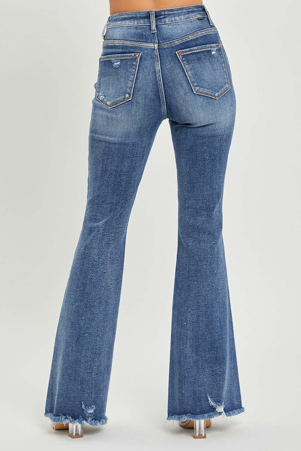 Back view of high waist distressed flare jeans with Risen Jeans branding showcasing trendy urban chic style and vintage-inspired flare legs.