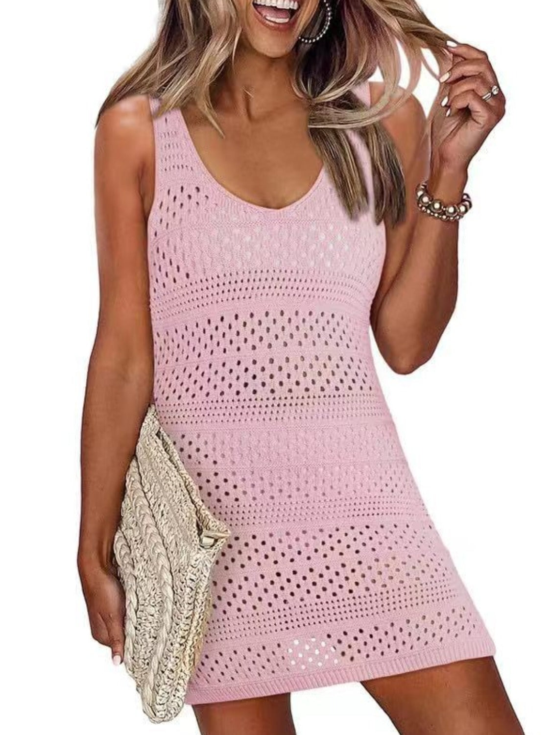 Playful woman in pink openwork scoop neck cover-up, perfect for beach days and sun-filled adventures.