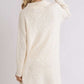 Back view of Umgee high-low boucle sweater dress in cream, showcasing cozy fabric and modern style.