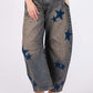 SAGE + FIG Star Wide Leg Jeans with Pockets featuring a chic wide-leg design and star embellishments for a trendy look.