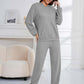 Woman in gray Bella Road hoodie and pants set, cozy and stylish for lounging or errands. Relaxed fit and slightly stretchy fabric.