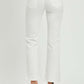 White mid-rise bootcut jeans with pockets, shown from the back, paired with clear-heeled sandals for a stylish look.