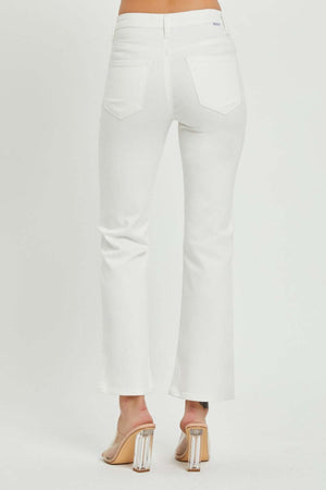 White mid-rise bootcut jeans with pockets, shown from the back, paired with clear-heeled sandals for a stylish look.