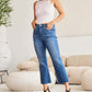 Woman wearing Mini Mia Full Size Tummy Control High Waist Jeans by RFM Jeans, showing the flattering fit and stylish design.