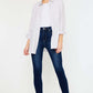 Woman wearing High Rise Frayed Ankle Skinny Jeans styled with white top and light jacket, showcasing trendy and stylish everyday look.