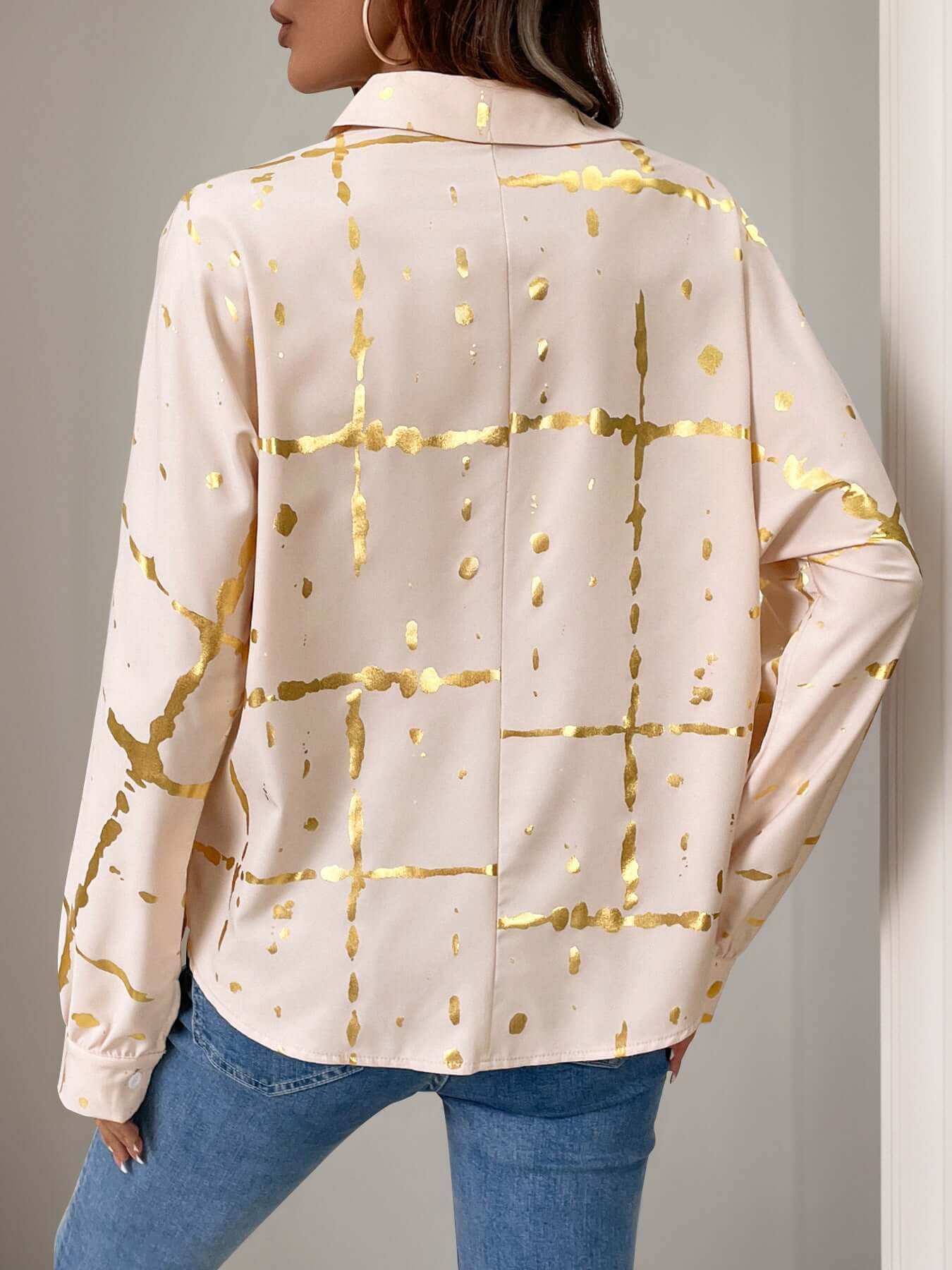 Woman wearing Perfee's tan long sleeve shirt with gold print, collared neck, and jeans, showcasing elegant fashion style.