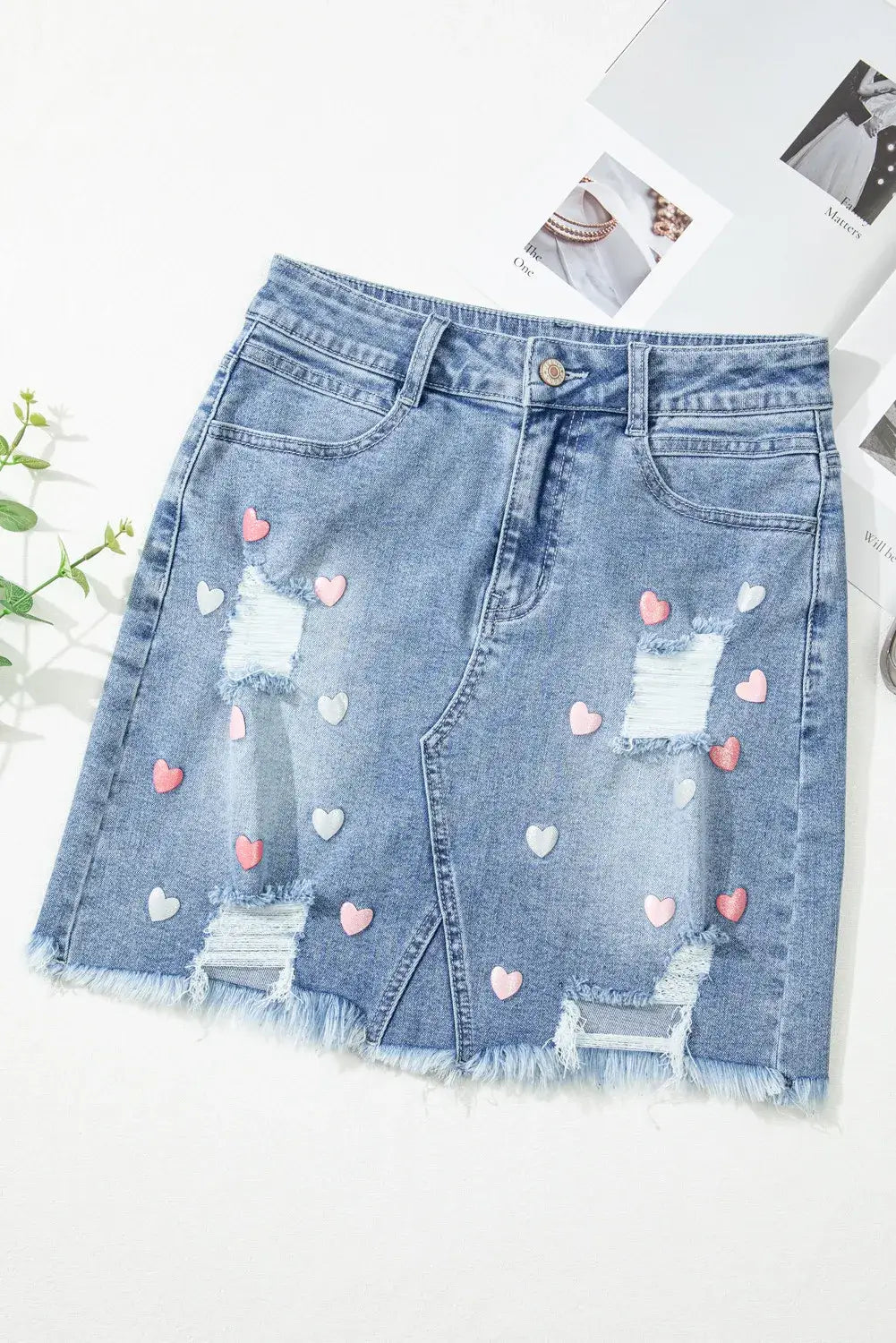 Bella Road Distressed Raw Hem Heart Mini Denim Skirt with playful heart design and edgy distressed look, perfect for casual outings.