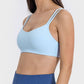 Light blue scoop neck cami with double straps, perfect for workouts or casual wear, showcasing moderate stretch and comfort.