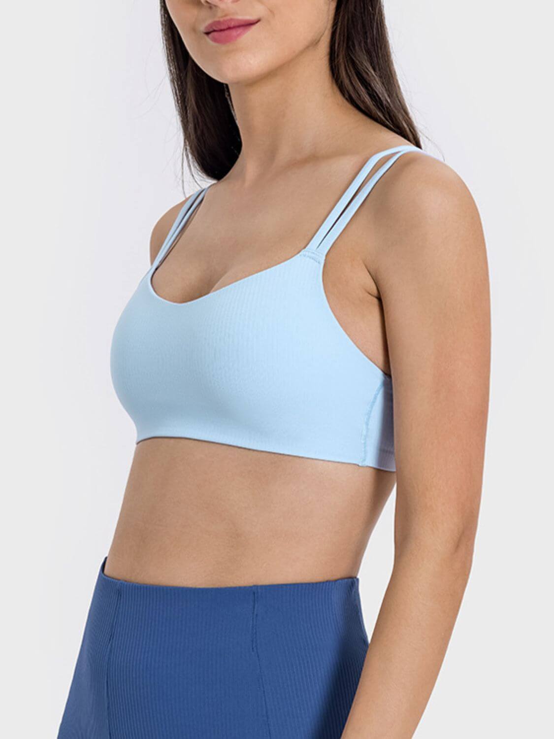 Light blue scoop neck cami with double straps, perfect for workouts or casual wear, showcasing moderate stretch and comfort.