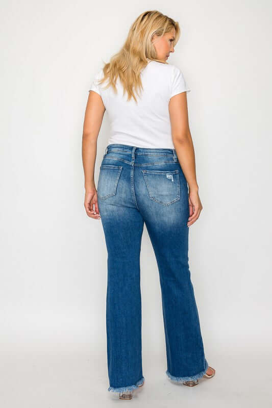 Woman wearing bytos Full Size Raw Hem Distressed High Rise Bootcut Jeans from the back, showcasing the stylish flare and raw hem.