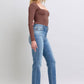 Woman wearing Judy Blue vintage wash thermal straight jeans with pockets and a brown long-sleeve top, showcasing a stylish look.