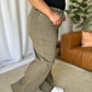 High Rise Garment Dye Wide Leg Jeans on person in living room setting with casual top and white sneakers.