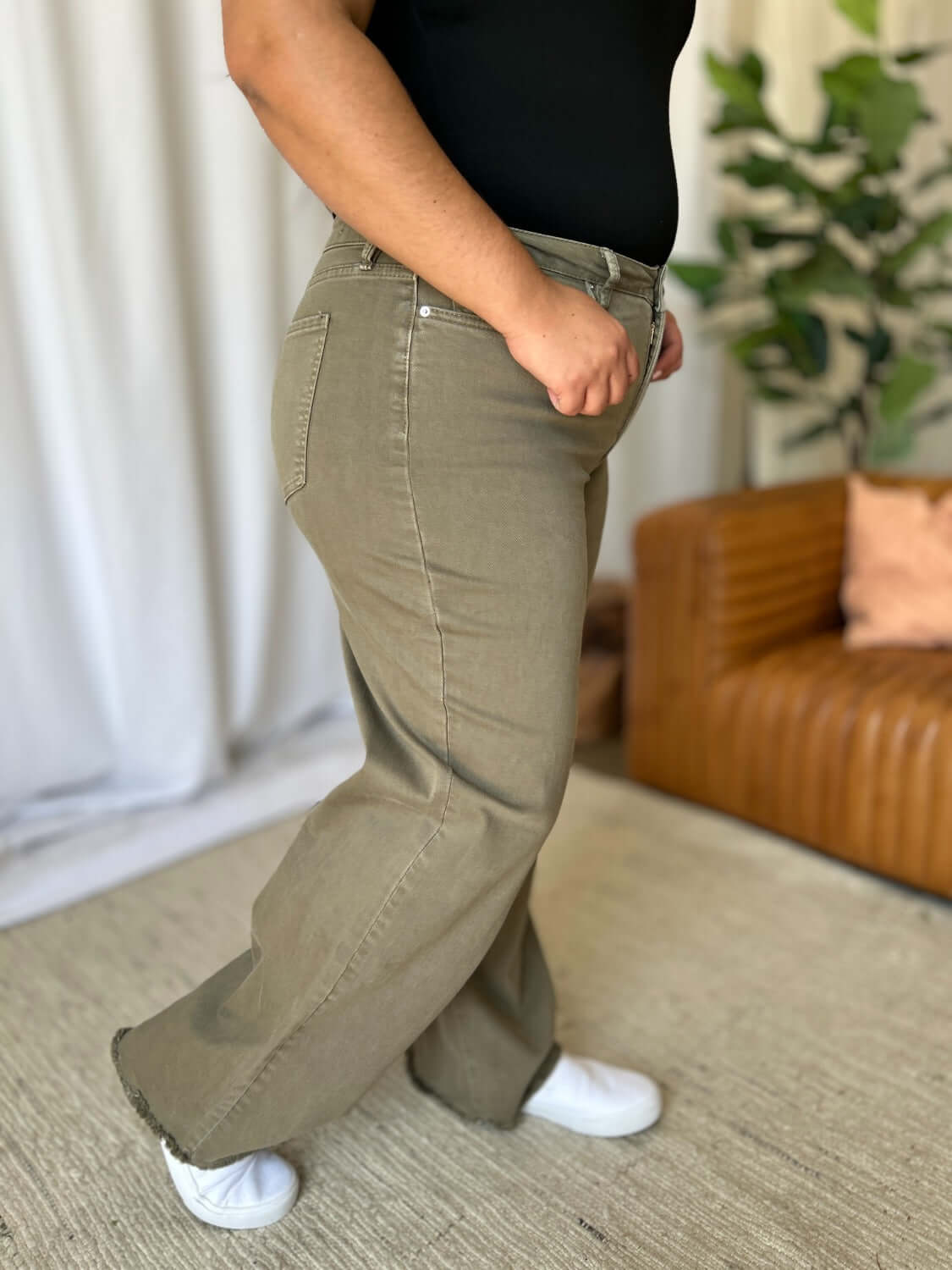 High Rise Garment Dye Wide Leg Jeans on person in living room setting with casual top and white sneakers.