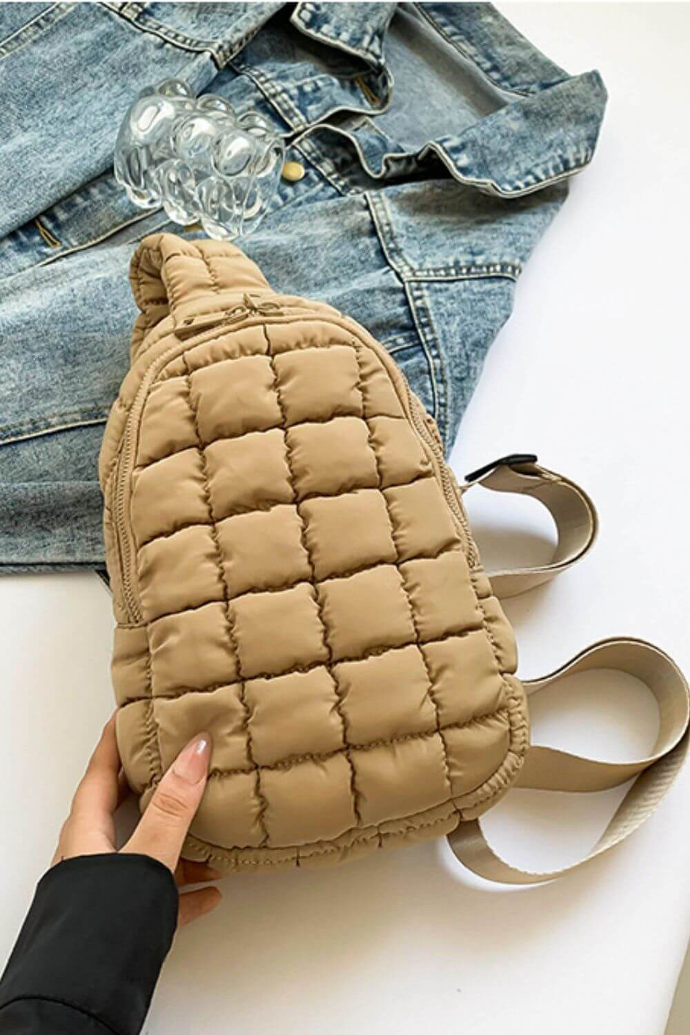 Bella Road Quilted Nylon Crossbody Bag in beige with denim jacket background, lightweight and stylish for any adventure.