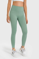 Model wearing Millennia High Waist Ankle-Length Yoga Leggings in green, perfect for yoga and stylish workouts.