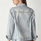 Woman wearing distressed button-up jacket by Risen Jeans, showing back details of the worn-in, rugged design.