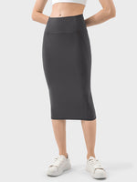 Black Millennia Slit Wrap Active Skirt with stretchy fabric, paired with casual sneakers for a sporty look.