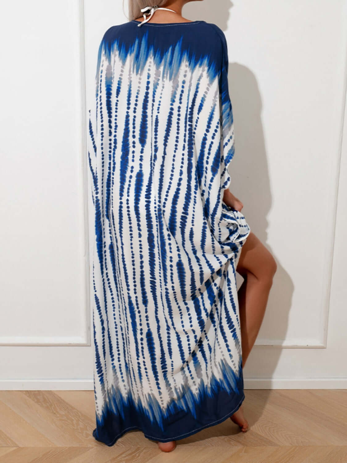 Woman wearing blue and white slit tie-dye half sleeve cover up made of 100% cotton, showcasing basic style and slightly stretchy fabric.