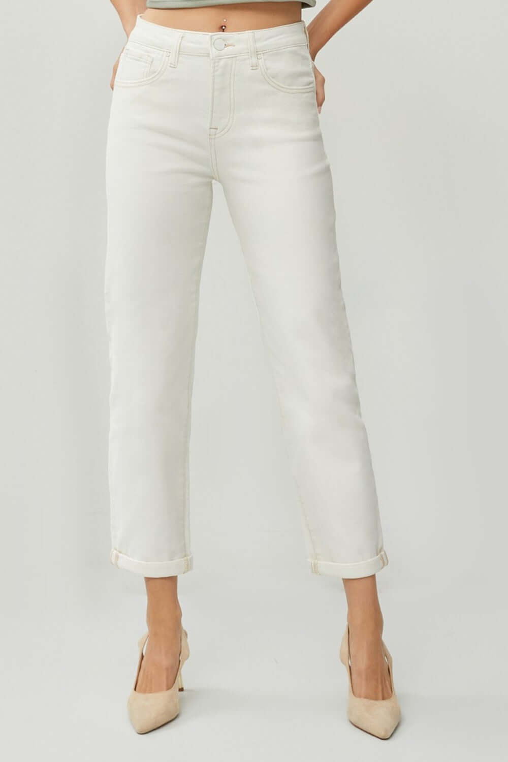 Woman wearing RISEN Full Size High Waist Rolled Hem Straight Jeans in white, paired with beige heels.