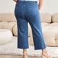 Woman wearing Crop Chloe Full Size Tummy Control High Waist Raw Hem Jeans from RFM Jeans in blue.