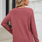 Woman wearing Bella Road waffle-knit notched long sleeve T-shirt in dusty rose, viewed from the back, paired with blue jeans.