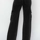 Back view of black high-rise wide leg cargo jeans with cargo pockets from Risen Jeans.