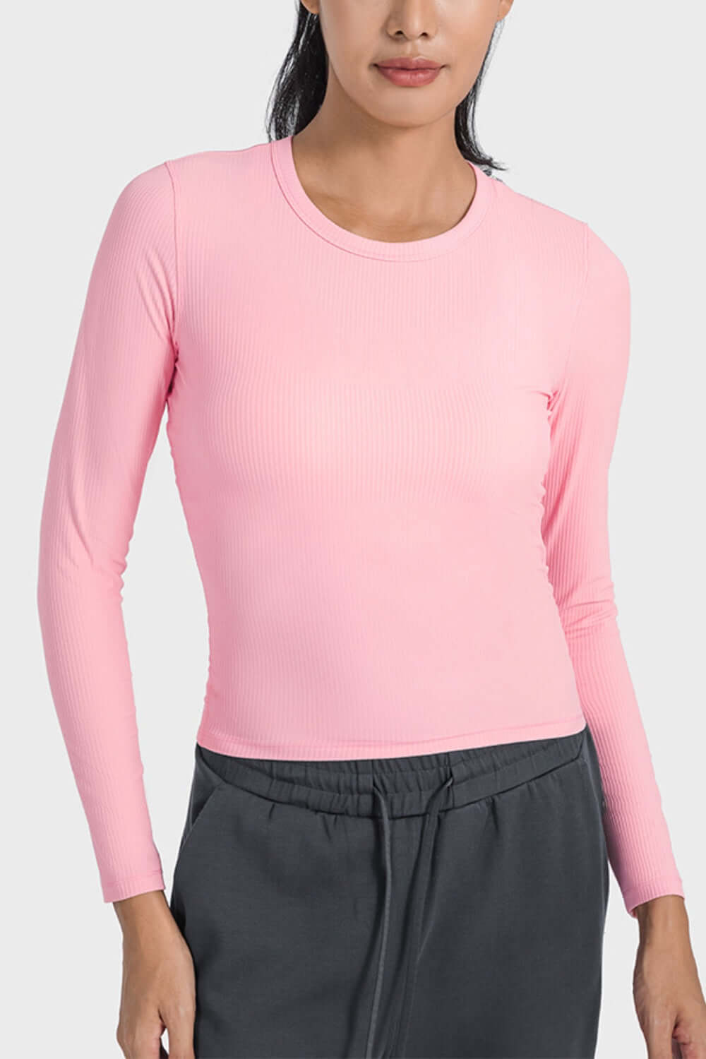 Millennia Round Neck Long Sleeve Sports Top in pink, showcasing a stylish and breathable design for workouts and lounging.