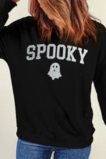 Woman wearing black Bella Road SPOOKY round neck sweatshirt with ghost design, long sleeves, perfect for Halloween fashion.